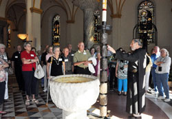 Benedictine Brother Maurus Zoeller, guest house manager and director of retreat programs, gives a tour of Saint Meinrad Archabbey&rsquo;s Church of Our Lady of Einsiedeln in St. Meinrad on Aug. 6 for pilgrims participating in the archdiocesan summer pilgrimage. The pilgrims also visited Monastery Immaculate Conception, the home of the Sisters of St. Benedict, in Ferdinand, Ind., and Abbey of Gethsemani in Trappist, Ky., during the three-day pilgrimage. (Photo by Mary Ann Garber)
