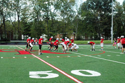 Members of the football team of Cardinal Ritter High School in Indianapolis practice on the school&rsquo;s new multi-sport athletic field on Sept. 12. The field is a source of pride for the Cardinal Ritter community. (Photo by John Shaughnessy)