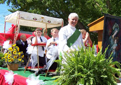 Permanent deacon Rick Cooper rides on St. Mary Parish&rsquo;s float on Sept. 15. (Submitted photo)