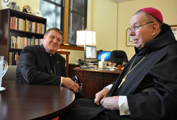 Archbishop Joseph W. Tobin, left, meets Archbishop Emeritus Daniel M. Buechlein in the chancery at the Archbishop Edward T. O&rsquo;Meara Catholic Center in Indianapolis on Oct. 18. (Photo by Sean Gallagher)