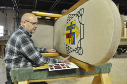 Bob Hermann, the owner of Wm. Hermann and Son, a woodworking company in&nbsp;Indianapolis, takes apart Archbishop Emeritus Daniel M. Buechlein&rsquo;s tapestry-covered cathedra on Nov. 7 to rebuild it with Archbishop Joseph W. Tobin&rsquo;s coat of arms carved in wood in time for the new archbishop&rsquo;s installation Mass on Dec. 3 at SS. Peter and Paul Cathedral in Indianapolis. (Photo by Mary Ann Garber)