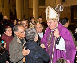 After celebrating Mass at his home parish, Holy Redeemer Church in Detroit, on Nov. 25, 2010, Archbishop Joseph W. Tobin stands in the church&rsquo;s main aisle greeting parishioners for more than a half-hour. Archbishop Tobin was baptized at the church and was its pastor for several years after being ordained a priest. (Photos by Larry A. Peplin, The Michigan Catholic)