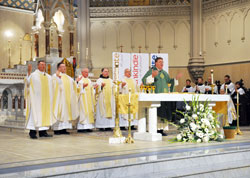 Archbishop Joseph W. Tobin, center, concelebrates Mass on Jan. 19 with, from left, Fathers Rick Nagel, Michael O&rsquo;Mara, George Plaster, Franciscan Father Lawrence Janezic, Father John Hall and Father Thomas Murphy (seated to the right of the altar). Father Hall was baptized and raised in St. John the Evangelist Parish in Indianapolis, and Father Murphy is a former pastor of the parish. (Photo by Natalie Hoefer)