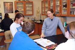 Bishop Chatard High School teacher Stephanie Theis shares a fun moment with senior Maggie McNelis and other students during a biology class. Besides teaching and coaching at the Indianapolis North Deanery interparochial school, Theis also volunteers at Brooke&rsquo;s Place, an organization that provides support and services to grieving children and their families. (Photo by Michael Sahm)
