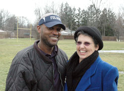 Demetrius Folsom and Peggy O&rsquo;Connor-Campbell flash smiles in recalling the success that the fifth- and sixth-grade football team of the Mother Theodore Catholic Academies in Indianapolis had during the 2012 season of the Catholic Youth Organization. O&rsquo;Connor-Campbell taught Folsom in grade school and asked him to coach the team. (Photo by John Shaughnessy)
