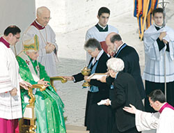 Providence Sister Denise Wilkinson, general superior of the Sisters of Providence of Saint Mary-of-the-Woods, Philip McCord and Providence Sister Marie Kevin Tighe offer gifts to Pope Benedict XVI during the canonization liturgy for four saints, including Blessed Mother Theodore Gu&eacute;rin, on Oct. 15, 2006, at St. Peter&rsquo;s Square in Rome. (Photo by Kelly Wilkinson/The Indianapolis Star)