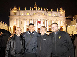 Seminarian Matthew Tucci, left, transitional Deacon Martin Rodriguez, seminarian Anthony Hollowell and transitional Deacon Douglas Marcotte pose on March 12 in St. Peter&rsquo;s Square at the Vatican. It was the first day of the conclave that elected Cardinal Jorge Mario Bergoglio of Buenos Aires as pope. The seminarians, who are receiving their priestly formation at the Pontifical North American College in Rome, were in the square the next night to see Pope Francis introduced. (Submitted photo)