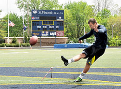 Michael Josifovski practices kicking field goals on May 6 at St. Vincent Health Field at Marian University in Indianapolis. Josifovski, a star kicker for the past two seasons for Marian&rsquo;s national championship football team, will participate in the Indianapolis Colts&rsquo; rookie minicamp from May 10-12. (Photo by Sean Gallagher)
