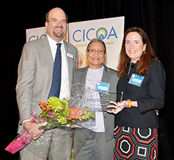JoAnn Fowler Combs, center, receives the Central Indiana Council on Aging, Inc. (CICOA) Caregiver of the Year award from Orion Bell IV, left, CICOA&rsquo;s president and CEO, and Mary Beth Tuohy, chair of CICOA&rsquo;s board of directors, at a breakfast held at the Ritz Charles in Carmel on April 18. (Submitted photo)