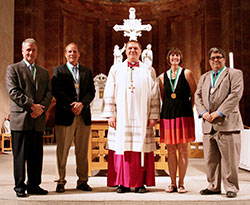 Four of the 2013 St. John Bosco Award recipients pose for a photograph with Archbishop Joseph W. Tobin during the Catholic Youth Organization Volunteer Awards Ceremony on May 7 at SS. Peter and Paul Cathedral in Indianapolis. They are, from left, Phil Kenney, Paul Weaver, Sandy Clegg and Tom Hayes. The fifth recipient, Mary Jo Reed, wasn&rsquo;t able to attend the ceremony because she was traveling out-of-state. (Photo by Jennifer Peterson)