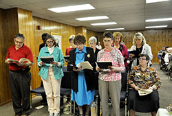 The graduating class of the Benedict Inn&rsquo;s Spiritual Direction Internship program recites a prayer at the end of their graduation ceremony at the Benedict in Retreat and Conference Center in Beech Grove on April 25. Front row, from left: John Hosier, Donna Wenstrup, Mary Ellen Allig, Leslie Miskowiec and Benedictine Sister Julie Sewell. Back row: Father Ben Okonkwo, Barb Dahl, Judy Fackenthal, Ann Littlefield and Melissa Jackson. Graduates Cindy Sturgeon and Deb Doty are not pictured. (Photo by Natalie Hoefer)
