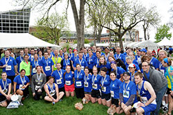 Members of the Race for Vocations team pose on May 4 outside the team&rsquo;s tent in Military Park in Indianapolis after they participated in either the OneAmerica 500 Festival Mini-Marathon or the Finish Line 500 Festival 5K. The approximately 300 team members wore shirts that promoted the belief that every person has a vocation from God. (Submitted photo)