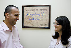 A refugee from Iraq, Basim Najeeb, left, has not only made a new life in Indianapolis with the help of Catholic Charities Indianapolis, he also helps new refugees through his work with the archdiocese&rsquo;s Refugee Resettlement Program. Here, he talks with Teresa Jones, match grant coordinator for the Refugee Resettlement Program. (Photo by John Shaughnessy)