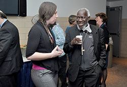 Marian University student and global studies minor Kelly Hoehn speaks with Bishop Paride Taban of South Sudan at a reception following the retired bishop&rsquo;s lecture as part of Marian University&rsquo;s Richard G. Lugar Franciscan Center for Global Studies Speaker Series at Marian University in Indianapolis on April 17. (Photo by Natalie Hoefer)