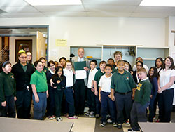 Attorney Michael Paton is surrounded by students as he serves as &ldquo;Principal for a Day&rdquo; at Holy Cross Central School in Indianapolis. (Submitted photo)