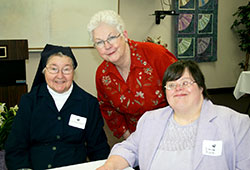 Susan Robinson, center, smiles with Daughters of Charity Sister Rosaria Raidl, left, and New Hope participant Dana Zunk after Robinson received the St. Vincent New Hope &ldquo;Hope Award&rdquo; at St. Vincent New Hope in Indianapolis. (Submitted photo)