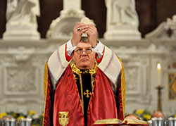 Archbishop Joseph W. Tobin elevates the Eucharist during his installation Mass on Dec. 3, 2012, at SS. Peter and Paul Cathedral in Indianapolis. He will receive his pallium from Pope Francis during a special Mass at St. Peter&rsquo;s Basilica at the Vatican on June 29. (File photo by Mary Ann Garber)