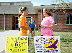 Katina Tekulve, left, and Kristy Lowe discuss plans for the &ldquo;On Eagle&rsquo;s Wings&rdquo; 5K Run/Walk that will celebrate the lives of Stephen and Denise Butz and Donald and Barbara Horan during the festival at St. Mary Parish in Greensburg on Aug. 24. Tekulve is logistical coordinator of the event while Lowe is the sponsorship coordinator. (Submitted photo)