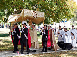 Father Robert Robeson, rector of the Bishop Simon Brut&eacute; College Seminary in Indianapolis, carries the monstrance during the &ldquo;Eucharistic Rosary Rally for the Protection of Our Religious Liberties&rdquo; procession on Sept. 30, 2012, at Marian University in Indianapolis. (Criterion file photo)