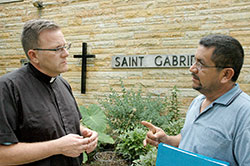 Rolando Mendoza Sr. makes a point about the need for immigration reform in the United States to Father Michael O&rsquo;Mara, pastor of St. Gabriel the Archangel Parish in Indianapolis. The priest and the parishioner both support the Catholic Church&rsquo;s emphasis that &ldquo;humane&rdquo; reform is needed. (Photo by John Shaughnessy)