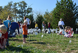 Children and other participants in an Oct. 12 &ldquo;40 Days for Life&rdquo; rally plant small flags in the ground in front of a Planned Parenthood abortion facility in Indianapolis. The flags represent the average 4,000 abortions that take place every working day each year in the United States. (Submitted photo)