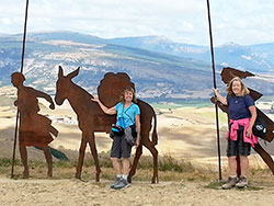 Ann Tully, right, and Carolyn Webster, recently traveled to France and Spain to walk along the ancient pilgrimage path known as &lsquo;The Way.&rdquo; Here, they pose for a photo by the Alto del Perdon, the &ldquo;Mount of Forgiveness,&rdquo; a sculpture dedicated to the pilgrims who travel the path that leads to the shrine of St. James at Santiago de Compostela in Spain. (Submitted photo)