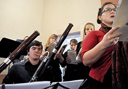 Instrumentalists and vocalists play and sing Wolfgang Amadeus Mozart&rsquo;s Requiem Mass in D minor during a Nov. 2 All Souls Day Mass at Our Lady of the Most Holy Rosary Church in Indianapolis. Owen Carlos, left, a music student at Butler University in Indianapolis, plays the bassoon, while Ann Lewis, Andrea Stanley, Noelle Brown and Alison Gudan, all Holy Rosary parishioners, sing. (Photo by Sean Gallagher)