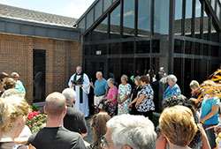 Conventual Franciscan Father Joseph West, pastor of St. Anthony of Padua Parish in Clarksville, leads a dedication service of a new preschool building for the parish&rsquo;s school on July 14, 2013. An influx of students with state-funded vouchers and scholarships via scholarship-granting organizations allowed it to expand its preschool. (File photo by Natalie Hoefer)