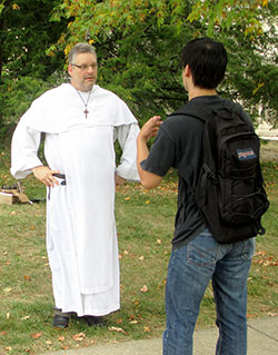 Dominican Father Simon-Felix Michalski, associate pastor of St. Paul Catholic Center, talks with an Indiana University student on the Bloomington campus in this Aug. 26, 2013, photo. Father Simon is meeting weekly with the student leaders of the small group program the parish&rsquo;s campus ministry launched this semester. (Photo courtesy Jon Blau of the Herald-Times)
