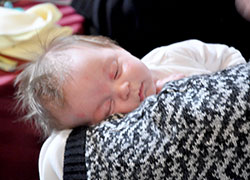 Cooper Featherling, 12-weeks-old, is held by a member of Annunciation Parish in Brazil. Cooper&rsquo;s mother, Lindsay Featherling, also of Annunciation Parish, brought her infant son to the Sanctity of Life Dinner on March 6 in Indianapolis. (Photo by Natalie Hoefer)