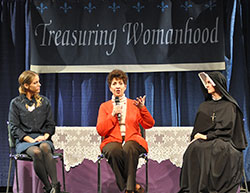 Janet Sahm, left, and Our Lady of Mercy Sister Caterina Esselen, right, listen as Julia Calandra-Lineberg answers a question from a woman attending the Indiana Catholic Women&rsquo;s Conference on March 22. (Photo by Natalie Hoefer)