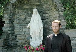 Deacon Daniel Bedel poses for a photo on May 19 at the Marian grotto behind St. John the Evangelist Church in Enochsburg&mdash;one of the two campuses of St. Catherine of Siena Parish in Decatur County. (Photo by John Shaughnessy)
