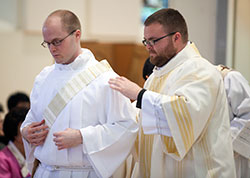 In this April 6, 2013, photo, transitional Deacon David Marcotte is vested by his brother, Doug&mdash;also a transitional deacon at the time&mdash;during a diaconate ordination in the Archabbey Church of Our Lady of Einsiedeln in St. Meinrad. Deacons Marcotte and Bedel will be ordained priests on June 7 at SS. Peter and Paul Cathedral in Indianapolis. (Photo courtesy of Saint Meinrad Seminary and School of Theology)