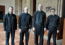 Transitional deacons Daniel Bedel, left, David Marcotte, Tim Wyciskalla and Benjamin Syberg pose on March 27 outside the St. Thomas Aquinas Chapel at Saint Meinrad Seminary and School of Theology in St. Meinrad. All four deacons, scheduled to be ordained priests on June 7 at SS. Peter and Paul Cathedral in Indianapolis, are graduates of Bishop Simon Brut&eacute; College Seminary in Indianapolis. (Photo by Sean Gallagher)