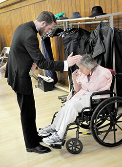 Newly ordained Father Daniel Bedel blesses Maryellen Scott, a resident of St. Augustine Home for the Aged in Indianapolis, during a reception held at the Archbishop Edward T. O&rsquo;Meara Catholic Center after the priesthood ordination on June 7 at SS. Peter and Paul Cathedral in Indianapolis. Scott began praying for and corresponding with then-seminarian Bedel eight years ago when he started at Bishop Simon Brut&eacute; College Seminary in Indianapolis. (Photo by Natalie Hoefer)