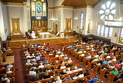 Members of St. Mary of the Immaculate Conception Parish in Rushville listen to Archbishop Joseph W. Tobin deliver a homily during a June 21 Mass in which he blessed the parish&rsquo;s recently renovated church. (Photo by Sean Gallagher)
