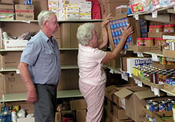 In this 2009 photo, Leroy and Marlene Oser, members of St. Martin of Tours Parish in Siberia, work at Martin&rsquo;s Cloak, a Tell City Deanery food pantry that is partially funded by money raised through the United Catholic Appeal: Christ Our Hope annual campaign. (Submitted photo)
