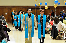 Eric Romero and his wife, Ana DeGante, members of St. Ambrose Parish in Seymour, process in with their classmates at a banquet celebrating the first graduating class of the archdiocesan Office of Intercultural Ministry&rsquo;s Hispanic Leadership Institute on May 11, 2013, at the Archbishop Edward T. O&rsquo;Meara Catholic Center in Indianapolis. The institute is one of three ethnic pastoral and catechetical formation programs operated by the archdiocesan Office of Intercultural Ministry. (Criterion file photo)