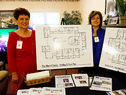 Phyllis Garmon, left, and Brenda Masden, members of the Providence Self-Sufficiency Ministries capital campaign committee, show the&nbsp;designs for two planned additions to the&nbsp;28-acre Georgetown campus on Sept. 19.&nbsp;An eight-bed unit will be a memory care home, and a&nbsp;10-bed&nbsp;&ldquo;villa&rdquo; or group home&nbsp;will provide skilled care. (Photo by Patricia Happel Cornwell)