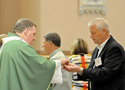 David Thomas, a member of Holy Spirit Parish of Indianapolis, receives the Eucharist from Archbishop Joseph W. Tobin on Sept. 17 at SS. Peter and Paul Cathedral in Indianapolis at a Mass held for those considering joining or renewing their membership in the Miter Society&mdash; those who donate $1,500 or more to the &ldquo;United Catholic Appeal: Christ Our Hope&rdquo; annual appeal. (Photo by Natalie Hoefer)