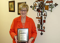 Annette &ldquo;Mickey&rdquo; Lentz shows the 2014 Woman for All Seasons Award that she received from the St. Thomas More Society of Indianapolis on Oct. 2. The society honored Lentz, the chancellor of the archdiocese, for her commitment to promote justice in the community. (Photo by John Shaughnessy)