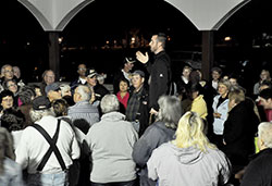 Father Dustin Boehm, center, pastor of St. Gabriel Parish in Connersville and St. Bridget of Ireland Parish in Liberty, gives instructions in the pavilion at Roberts Park in Connersville to more than 150 people on Oct. 12&mdash;prior to the first of nine parish-led Sunday evening rosary walks, praying for those suffering from addictions and their families. Connersville has had a recent upsurge in overdoses and deaths due to heroin use. (Photo by Natalie Hoefer)