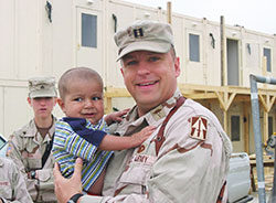 This 2005 photo captures St. Thomas of Aquinas Parish member Mike Roscoe holding Qudrat, a child in Afghanistan whose incredible journey to Indianapolis for heart surgery changed Roscoe&rsquo;s life, touched people&rsquo;s hearts and continues to pave the way for health care for children around the world. (Submitted photo)