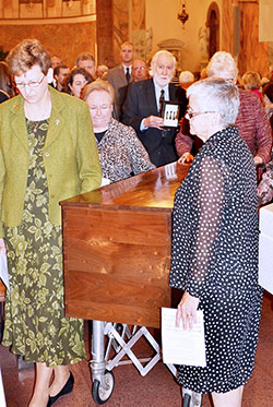 Providence Sisters Dawn Tomaszewski, left, Mary Beth Klingel, Lisa Stallings (partially obscured) and general superior Sister Denise Wilkinson process with the remains of St. Mother Theodore Gu&eacute;rin on Oct. 3 from the Church of the Immaculate Conception at Saint Mary-of-the-Woods to the saint&rsquo;s new permanent shrine connected to the church by a hallway. The open house for the new shrine is from 1-4 p.m. on Oct. 25. (Submitted photo)