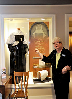 Providence Sister Jan Craven, coordinator of the Shrine of Saint Mother Theodore Gu&eacute;rin, describes the replica of the saint&rsquo;s habit during the shrine&rsquo;s open house on Oct. 25. (Photo by Natalie Hoefer)