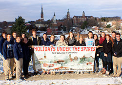 Students at Oldenburg Academy of the Immaculate Conception in Oldenburg display the banner they created to promote the community&rsquo;s annual &ldquo;Holidays Under the Spires&rdquo; event on Dec. 6. Members of the school&rsquo;s National Business Honor Society took the lead this year in planning and promoting the village&rsquo;s Christmas celebration. (Submitted photo)