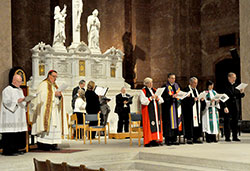 Archbishop Joseph W. Tobin, second from left, Episcopal Bishop Catherine Waynick, Rev. Richard Spleth, regional minister of the Christian Church (Disciples of Christ), Rev. Dr. Robert Welsh, ecumenical officer of the Christian Church (Disciples of Christ), Rev. Heather Apel of the Indiana-Kentucky Synod of the Evangelical Lutheran Church of America, and Father Rick Ginther, director of the archdiocesan Offiice of Ecumenism, sing a hymn during an ecumenical prayer service on Jan. 25 at SS. Peter and Paul Cathedral in Indianapolis. Also assisting in the service are master of ceremonies Loral Tansy, left, and members of Laudis Cantores, the cathedral&rsquo;s choir. (Photos by Sean Gallagher)