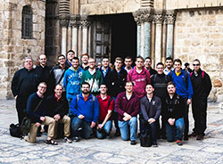 Seminarians from Bishop Simon Brut&eacute; College Seminary in Indianapolis and Saint Meinrad Seminary and School of Theology in St. Meinrad pose outside of the Church of the Holy Sepulcher in Jerusalem during a December 2014 pilgrimage to the Holy Land. Father Robert Robeson, at left, rector of Bishop Brut&eacute;, helped lead the pilgrimage. (Submitted photo)