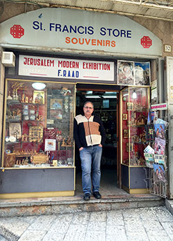 Alfred Ra&rsquo;ad stands inside the door of St. Francis Store, a souvenir shop in Old City Jerusalem, on March 13. A decline in the number of pilgrims visiting the Holy Land&mdash;plus a growing sense of persecution&mdash;have led to hard times for Ra&rsquo;ad and his family. (Submitted photo)