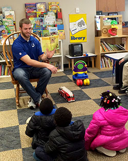 Indianapolis Colts&rsquo; tight end Jack Doyle reads a book to children during a visit to the Holy Family Shelter in Indianapolis on March 17. (Submitted photo)